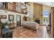 Cozy living room with a brick fireplace, terracotta tile flooring, and views of the upper level loft at 383 Brushwood Ln, Winter Springs, FL 32708