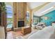 Inviting living room with a brick fireplace, terracotta tile, and seamless access to the dining area at 383 Brushwood Ln, Winter Springs, FL 32708