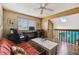 Upper-level home office with a comfortable couch, desk setup, and views of the outside at 383 Brushwood Ln, Winter Springs, FL 32708