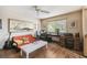 Home office with a comfortable couch, desk, computer setup, and a window overlooking the yard at 383 Brushwood Ln, Winter Springs, FL 32708