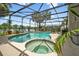 Gorgeous pool and jacuzzi featuring a screened enclosure and views of the lake at 383 Brushwood Ln, Winter Springs, FL 32708