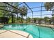 Backyard oasis with a screened pool offering a view of the nearby lake at 383 Brushwood Ln, Winter Springs, FL 32708