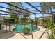 Backyard oasis with a screened pool, lake views, and a safety fence at 383 Brushwood Ln, Winter Springs, FL 32708