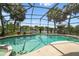 Backyard with a screened pool and patio, overlooking a tranquil lake at 383 Brushwood Ln, Winter Springs, FL 32708