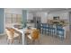 Open-concept dining area featuring stylish rattan chairs, a bright white table, and stainless steel appliances at 3896 Diving Dove Ln, Bartow, FL 33830