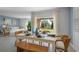 Cozy dining area with stylish rattan chairs, a bright white table, and large windows at 3896 Diving Dove Ln, Bartow, FL 33830