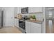 Modern kitchen featuring white cabinets, stainless steel appliances, and a granite countertop at 3896 Diving Dove Ln, Bartow, FL 33830