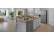 Bright kitchen with a granite countertop island and modern stainless steel appliances at 3896 Diving Dove Ln, Bartow, FL 33830