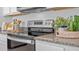 Sleek glass top range with stainless steel trim complemented by granite countertops for a modern kitchen design at 3896 Diving Dove Ln, Bartow, FL 33830