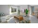 Bright living room with large window, modern decor, and stylish furniture perfect for gathering and relaxation at 3896 Diving Dove Ln, Bartow, FL 33830