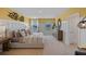 Inviting bedroom featuring wainscotting, large windows, and neutral tones creating a comfortable and relaxing atmosphere at 3908 Diving Dove Ln, Bartow, FL 33830