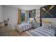 Stylish bedroom with two twin beds, a navy accent wall with nautical decor, and bright orange curtains at 3908 Diving Dove Ln, Bartow, FL 33830