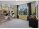 Study room featuring two desks with chairs and a black cabinet with shelves and decor and view of the outdoor at 3908 Diving Dove Ln, Bartow, FL 33830