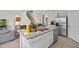 Open kitchen island with stainless steel sink and seating, connecting to the living area at 3908 Diving Dove Ln, Bartow, FL 33830