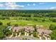 An aerial view showcases the golf course-adjacent neighborhood and townhomes at 3928 Villas Green Cir, Longwood, FL 32779