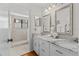 Elegant bathroom with marble countertop, double mirrors, and walk-in shower at 3928 Villas Green Cir, Longwood, FL 32779