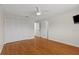 Spacious bedroom featuring hardwood floors, ceiling fan, and large closet at 3928 Villas Green Cir, Longwood, FL 32779