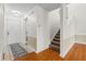 Clean Foyer featuring tile and hardwood flooring, staircase, and white walls at 3928 Villas Green Cir, Longwood, FL 32779