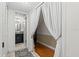 Hallway with tile flooring leading to an upstairs area with a bathroom and white curtain at 3928 Villas Green Cir, Longwood, FL 32779