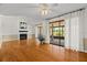 Bright living room with hardwood floors, a fireplace, and sliding doors leading to a screened porch at 3928 Villas Green Cir, Longwood, FL 32779