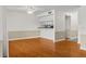 Bright living area with hardwood floors and view into the kitchen with bar top counter at 3928 Villas Green Cir, Longwood, FL 32779