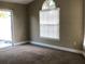 Bright living room with neutral tones, carpet, and a sliding glass door, offering seamless indoor-outdoor flow at 410 Horizon Dr, Winter Springs, FL 32708