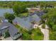 Aerial view showcases a sprawling single-Gathering home with lush greenery, a meticulously maintained lawn and lake access at 5108 Sailwind Cir, Orlando, FL 32810
