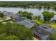 Scenic aerial view showcases lakefront property, featuring docks, and lush landscaping in a desirable community at 5108 Sailwind Cir, Orlando, FL 32810