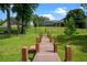 Lush backyard with a private dock, perfect for waterfront living and outdoor enjoyment at 5108 Sailwind Cir, Orlando, FL 32810