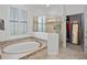 Primary bathroom with bathtub and glass shower at 5108 Sailwind Cir, Orlando, FL 32810