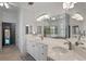 Primary bathroom with double sinks, bathtub, and large mirrors at 5108 Sailwind Cir, Orlando, FL 32810