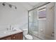 The bathroom has a single sink and a shower/bath with glass doors for a clean look at 5108 Sailwind Cir, Orlando, FL 32810