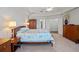 Primary bedroom featuring large windows, tray ceilings, and a ceiling fan at 5108 Sailwind Cir, Orlando, FL 32810