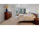 Primary bedroom featuring large windows, tray ceilings, and a ceiling fan at 5108 Sailwind Cir, Orlando, FL 32810