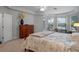 Primary bedroom featuring large windows, tray ceilings, and a ceiling fan at 5108 Sailwind Cir, Orlando, FL 32810