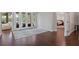 A bright entryway features hardwood floors, an area rug, and doors leading to an outdoor pool area at 5108 Sailwind Cir, Orlando, FL 32810