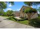 Charming home features a well-manicured lawn and a basketball hoop on a spacious driveway with lush landscaping at 5108 Sailwind Cir, Orlando, FL 32810