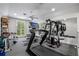 Home gym equipped with modern exercise equipment, mirrors and large windows for natural light at 5108 Sailwind Cir, Orlando, FL 32810