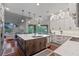 A spacious kitchen features an oversized island with bar seating, stainless steel appliances, and ample cabinet space at 5108 Sailwind Cir, Orlando, FL 32810