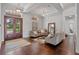 Elegant living room featuring hardwood floors, coffered ceilings, and a grand front entry with double doors at 5108 Sailwind Cir, Orlando, FL 32810
