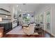 A bright living room features a stone fireplace, a ceiling fan, large windows and hardwood floors at 5108 Sailwind Cir, Orlando, FL 32810