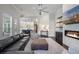 Spacious living room featuring fireplace, ceiling fan and view into eat-in kitchen at 5108 Sailwind Cir, Orlando, FL 32810