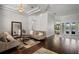 Comfortable living area with hardwood floors, a stylish mirror, and an open layout with water views at 5108 Sailwind Cir, Orlando, FL 32810