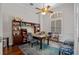 Bright office with built-in shelves, a ceiling fan, a window with shutters and an area rug at 5108 Sailwind Cir, Orlando, FL 32810