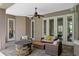 Inviting outdoor patio with stone fireplace and comfortable wicker seating under a ceiling fan at 5108 Sailwind Cir, Orlando, FL 32810