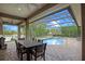Enclosed patio with beautiful pool and lake views, perfect for outdoor dining and relaxation at 5108 Sailwind Cir, Orlando, FL 32810