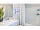 A clean, well-lit bathroom featuring modern fixtures, a shower-tub combo, and neutral decor for a calming space at 5113 Forget Me Not Ave, Lake Hamilton, FL 33851