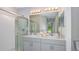 Well-lit bathroom with double vanity, large mirror, and a glass-enclosed shower at 5113 Forget Me Not Ave, Lake Hamilton, FL 33851