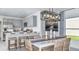 Elegant dining area with modern lighting, open to the kitchen, and ample seating at 5113 Forget Me Not Ave, Lake Hamilton, FL 33851