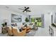 Bright living room with white furniture, patterned rug, and access to outdoor space at 5113 Forget Me Not Ave, Lake Hamilton, FL 33851